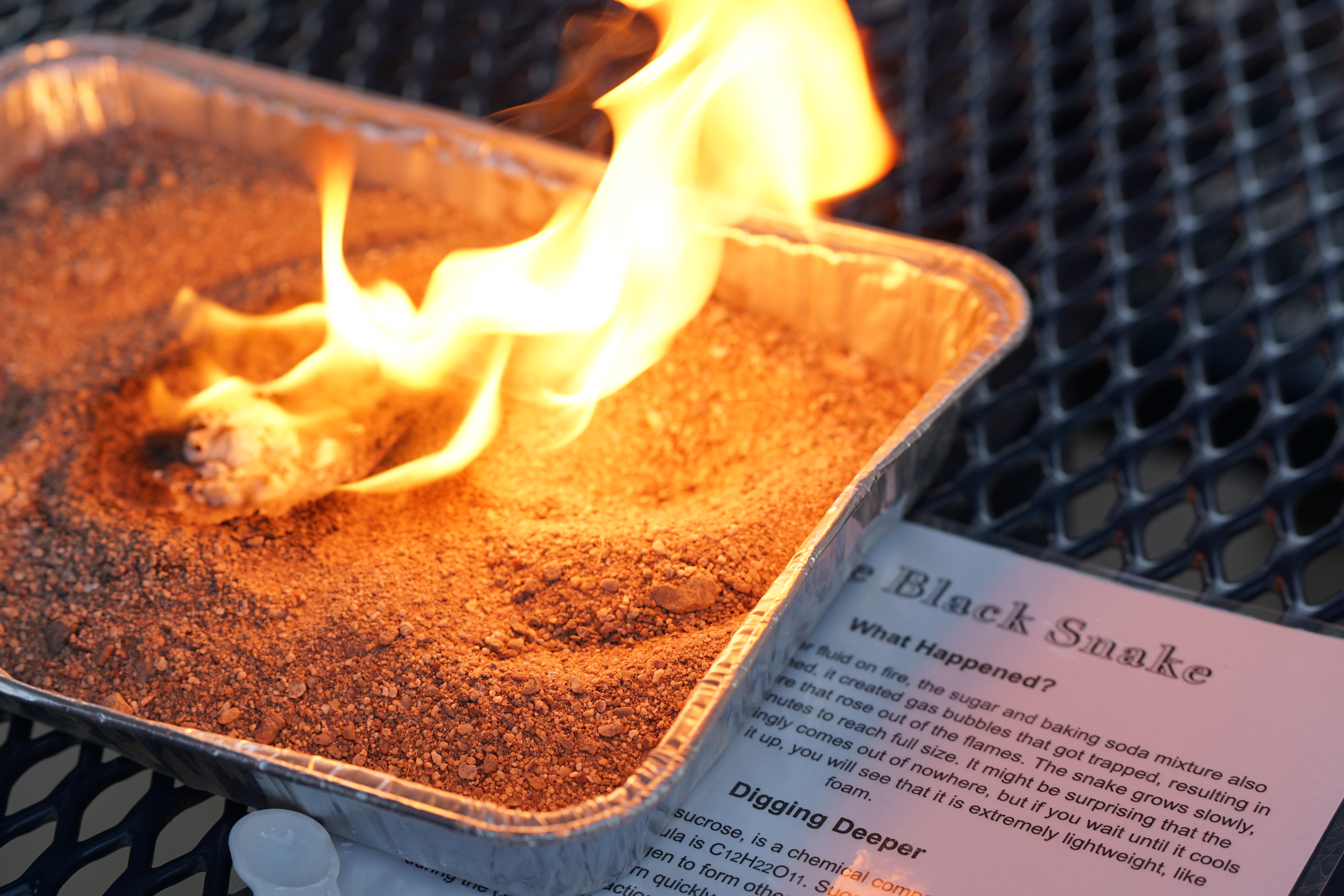 A small fire inside a metal baking tin