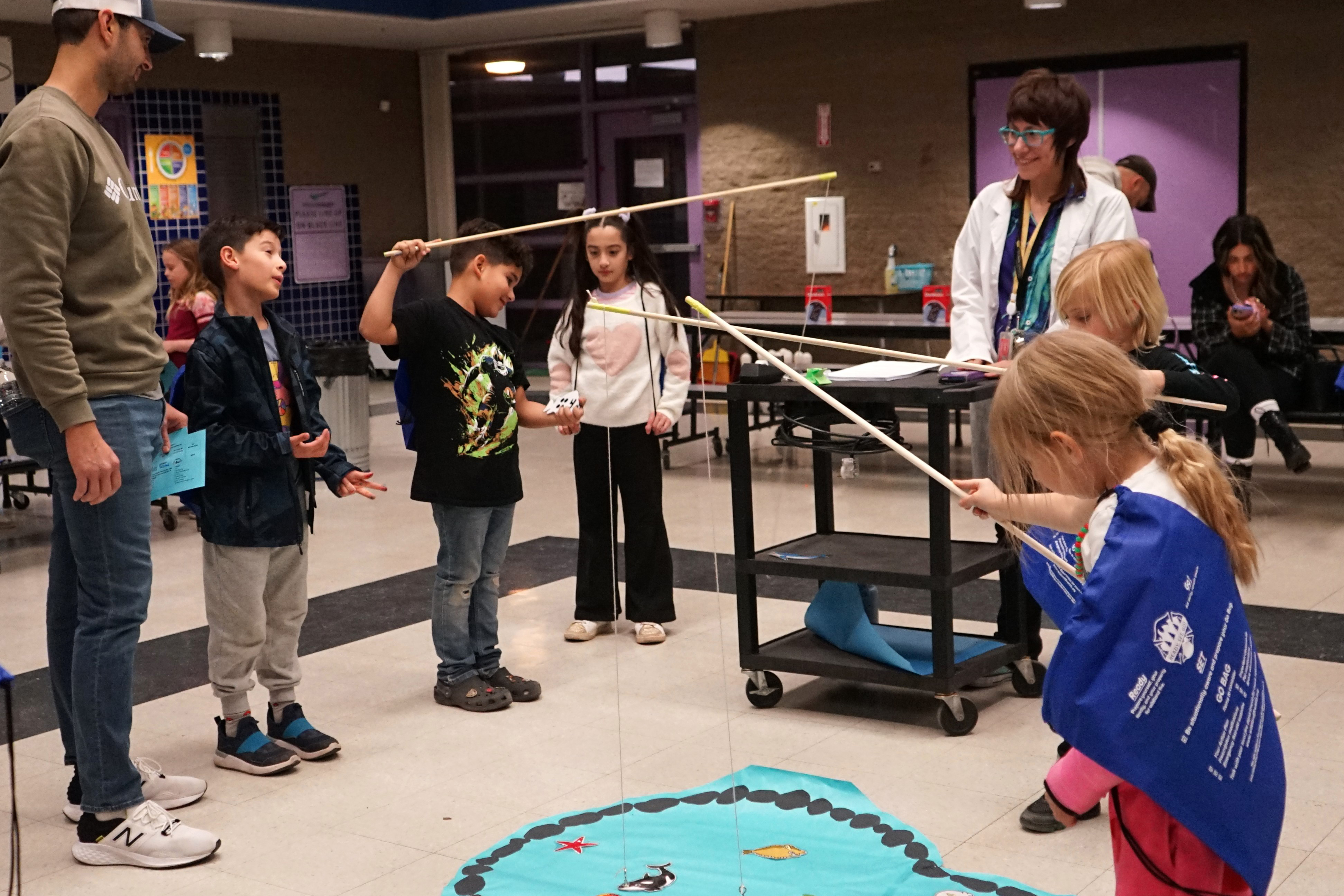 Students play a fishing game