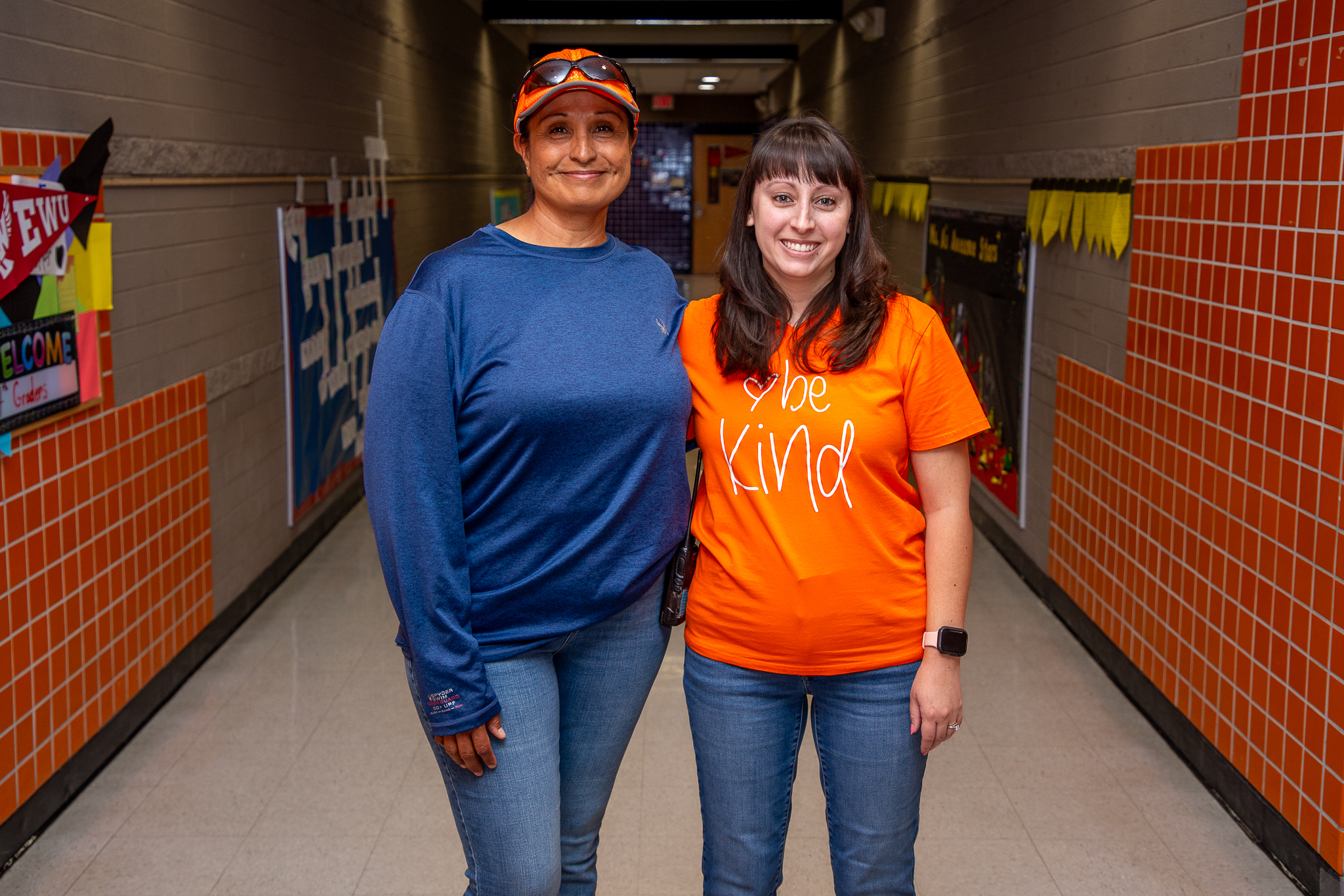 Christina and Rachel Castro smile together in the hallway at Robins